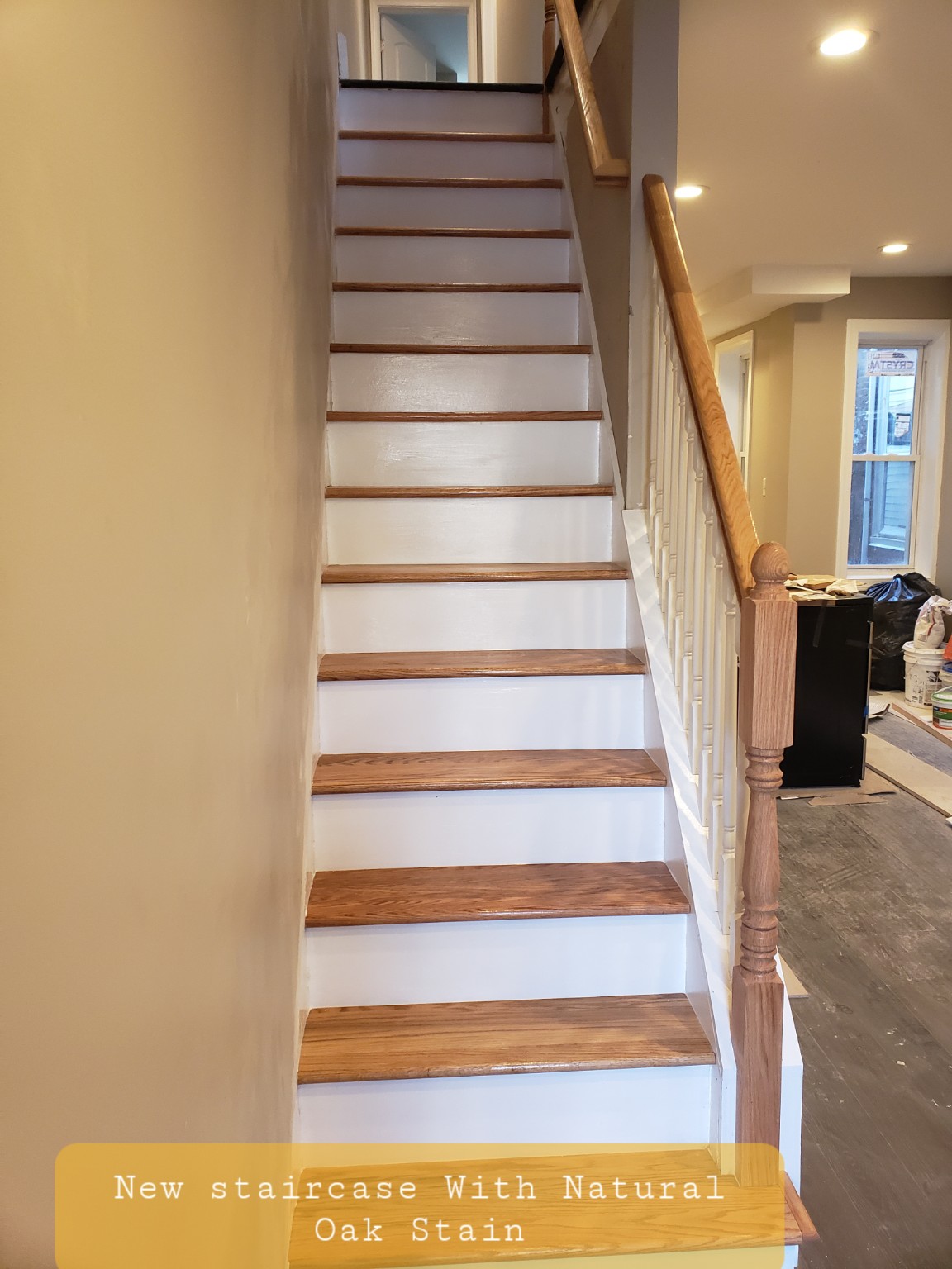 New staircase with natural oak stain and white risers